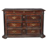An Italian walnut commode, second half 17th century, the moulded rectangular top above a shallow