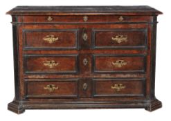 An Italian walnut commode, second half 17th century, the moulded rectangular top above a shallow