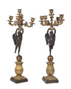 A pair of Restauration or Louis Philippe patinated and gilt bronze five light figural candelabra,