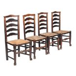 A set of eight elm and rush seated dining chairs , late 18th century, each with ladder back above a