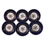 Six Worcester blue-ground plates, circa 1770 , the centres painted with floral sprays within gilt