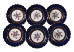 Six Worcester blue-ground plates, circa 1770 , the centres painted with floral sprays within gilt