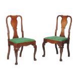 A pair of George II Irish mahogany side chairs, circa 1750, each cartouche shaped back centred by a