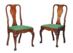 A pair of George II Irish mahogany side chairs, circa 1750, each cartouche shaped back centred by a