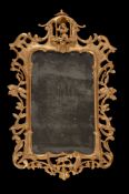 A pair of George III carved giltwood wall mirrors, circa 1780, each shaped rectangular plate within