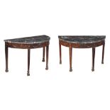 A pair of carved mahogany and granite mounted semi elliptical side tables, in George III style,