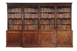 A George III mahogany breakfront library bookcase, circa 1780, the dentil and pendant moulded
