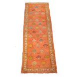 An Ushak gallery carpet or runner, the pale orange field decorated with stylised foliate motifs in
