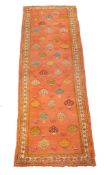 An Ushak gallery carpet or runner, the pale orange field decorated with stylised foliate motifs in