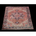 A Heriz carpet , decorated throughout with geomtric foliate motifs, the central navy, sky blue and