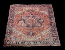 A Heriz carpet , decorated throughout with geomtric foliate motifs, the central navy, sky blue and