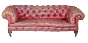 A Victorian oak and buttoned leather upholstered sofa, circa 1860, the rectangular shaped
