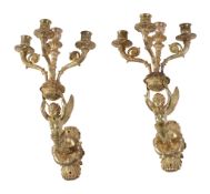 A pair of Empire or Restauration gilt bronze four light wall appliques in the manner of examples by