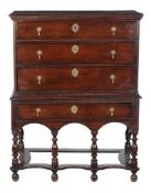 A George I oak chest on stand, circa 1720, the moulded rectangular top above three long drawers,