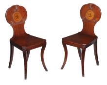 A pair of Regency mahogany hall chairs , circa 1815, each with shaped lobed and scrolled back with