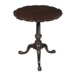 A George III carved mahogany tripod table , circa 1770, the hinged circular shaped top with