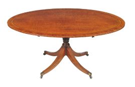 A George III plum pudding mahogany and satinwood crossbanded oval pedestal dining table, circa