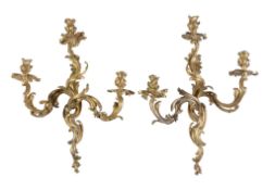 A fine pair of Louis XV ormolu three light wall appliques, circa 1760, cast as opposing, each with