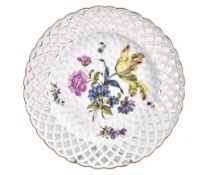 A Meissen ozier-moulded dessert plate with pierced border, circa 1760, pai nted with deutsche