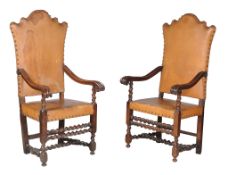 A pair of Italian walnut and studded leather upholstered armchairs, 18th century, each tapering