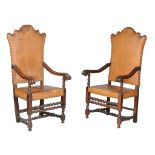 A pair of Italian walnut and studded leather upholstered armchairs, 18th century, each tapering