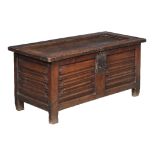 A carved and panelled oak chest, late 16th/ early 17th century, the hinged and panelled lid opening