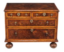 A William & Mary walnut oyster veneered and marquetry chest of drawers, circa 1690, holly banded