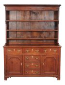 A pine dresser, late 18th/ early 19th century, the rack with a moulded cornice above three open