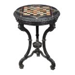 An ebonised and specimen marble chess table, circa 1850, the circular marble top with specimen