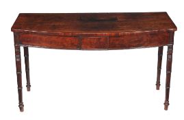 A George III mahogany bowfront serving table, circa 1810, the shaped top above a tablet moulded