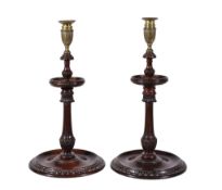 A large pair of carved and stained mahogany and brass mounted candlesticks in George III style,