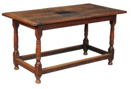 A Charles II oak 'hall' table, circa 1680, the triple plank top with cleated ends, above a moulded