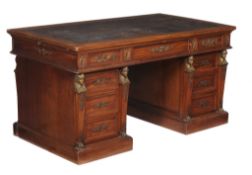 A Napoleon III mahogany and gilt metal mounted partners pedestal desk, circa 1870, in the Empire