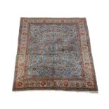 A Tabriz carpet, the blue field decorated with an overall design incorporating flowerheads and