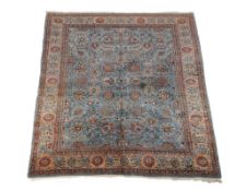 A Tabriz carpet, the blue field decorated with an overall design incorporating flowerheads and