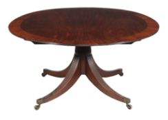 A George III mahogany circular dining table, circa 1790, the circular top with bookmatched centre