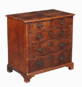 A George I walnut chest of drawers, circa 1720, the quarter veneered and featherbanded top above