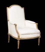 A Louis XVI carved giltwood armchair, circa 1775, the arched and padded rectangular back decorated