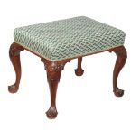 A George II mahogany stool , circa 1740, the overstuffed seat above tapering cabriole legs