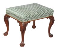 A George II mahogany stool , circa 1740, the overstuffed seat above tapering cabriole legs