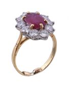 A ruby and diamond ring, the oval cut ruby claw set within a surround of brilliant cut diamonds,