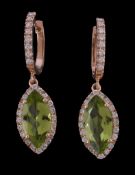 A pair of peridot and diamond earrings, the marquise cut peridot claw set within a surround of