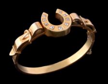 Equine interest, a Victorian diamond set gold hinged bangle, circa 1880, the central horseshoe