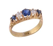 An early 20th century sapphire and diamond ring, the central circular cut sapphire claw set between
