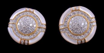 Ω A pair of mother of pearl and diamond earrings, the circular panels set with a cluster of