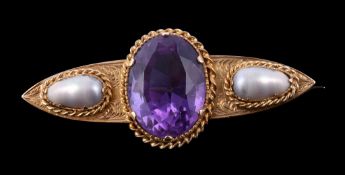 A late Victorian amethyst and pearl brooch, circa 1900, the central oval cut amethyst in a