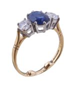 A sapphire and diamond three stone ring, the oval cut sapphire claw set between two brilliant cut