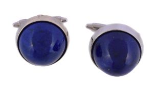 A pair of lapis lazuli cufflinks, the circular sugar loaf cabochon lapis lazuli, within polished