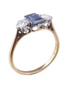 A 1920s sapphire and diamond three stone ring, the central rectangular cut sapphire claw set