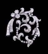 A diamond spray pendant, the swirling foliate spray set with brilliant cut and eight cut diamonds,
